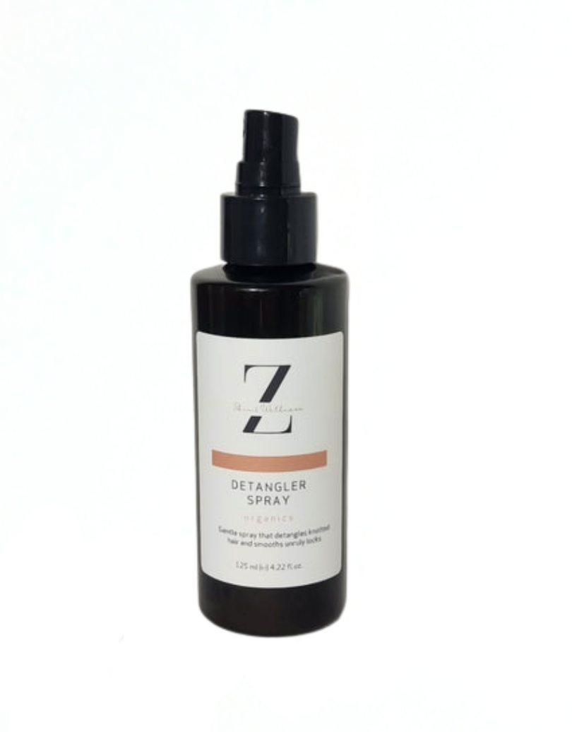 Detangler spray bottle with black cap and white label on a white background
